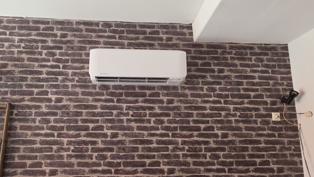 Witte Mitsubishi Heavy Industries airco op steenmotief wand in woonkamer Nieuw-WeerdingeWitte Mitsubishi Heavy Industries airco op steenmotief wand in woonkamer Nieuw-Weerdinge