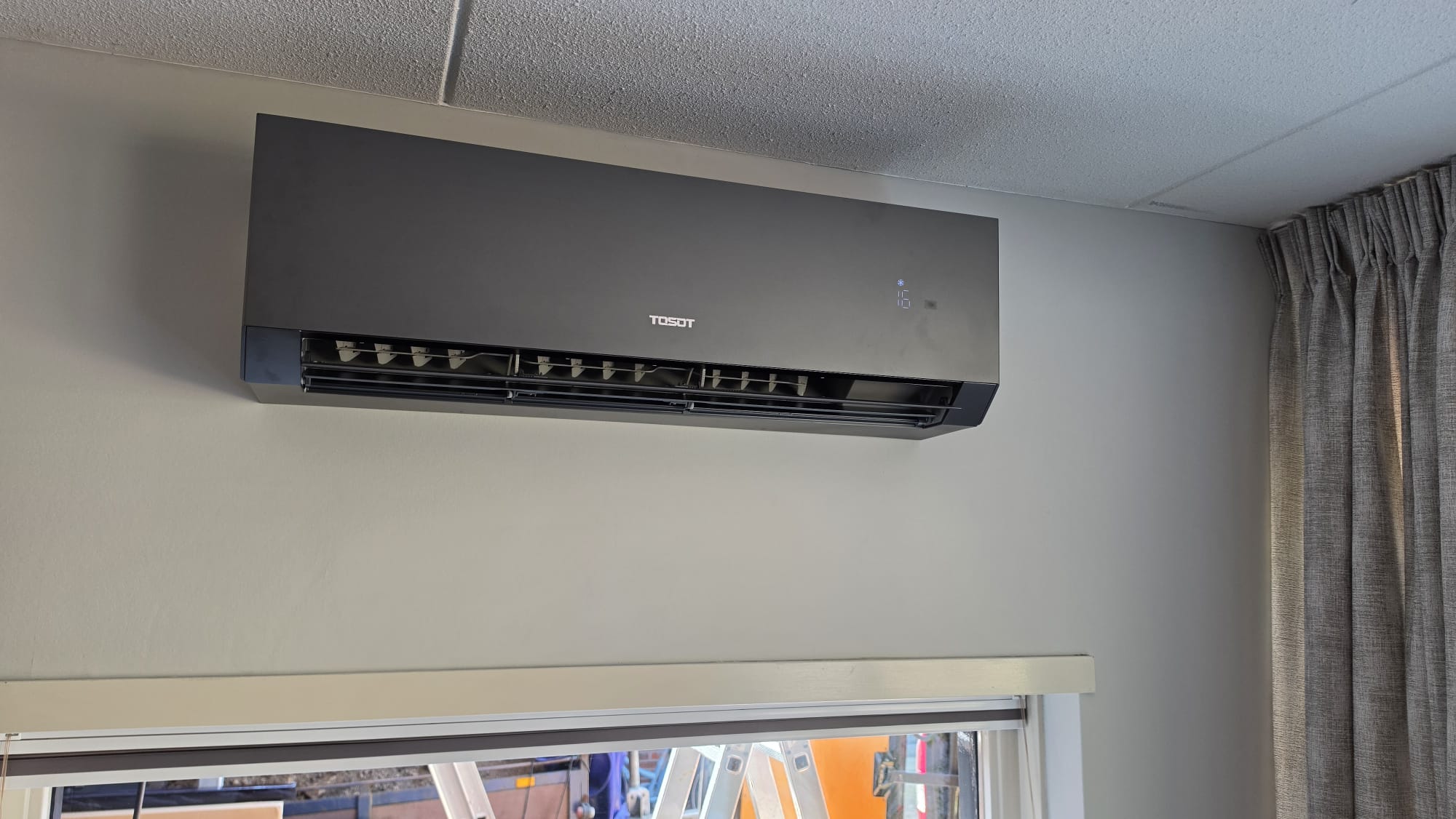 Tosot Clivia Black airco in woonkamer in Vroomshoop boven het raam