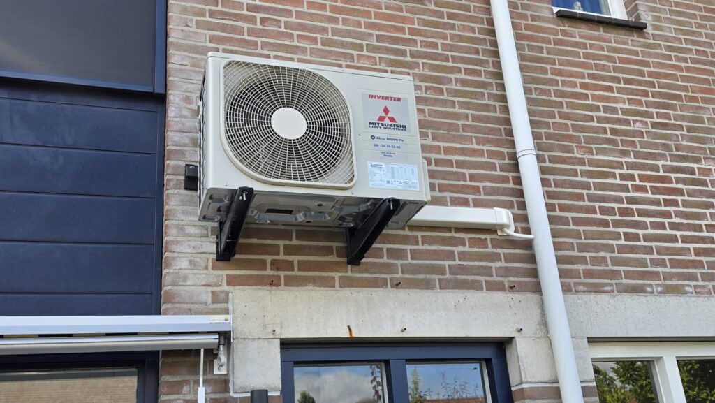 Mitsubishi Heavy Industries buitenunit op muurbeugels aan voorzijde woning in Zwolle-Zuid